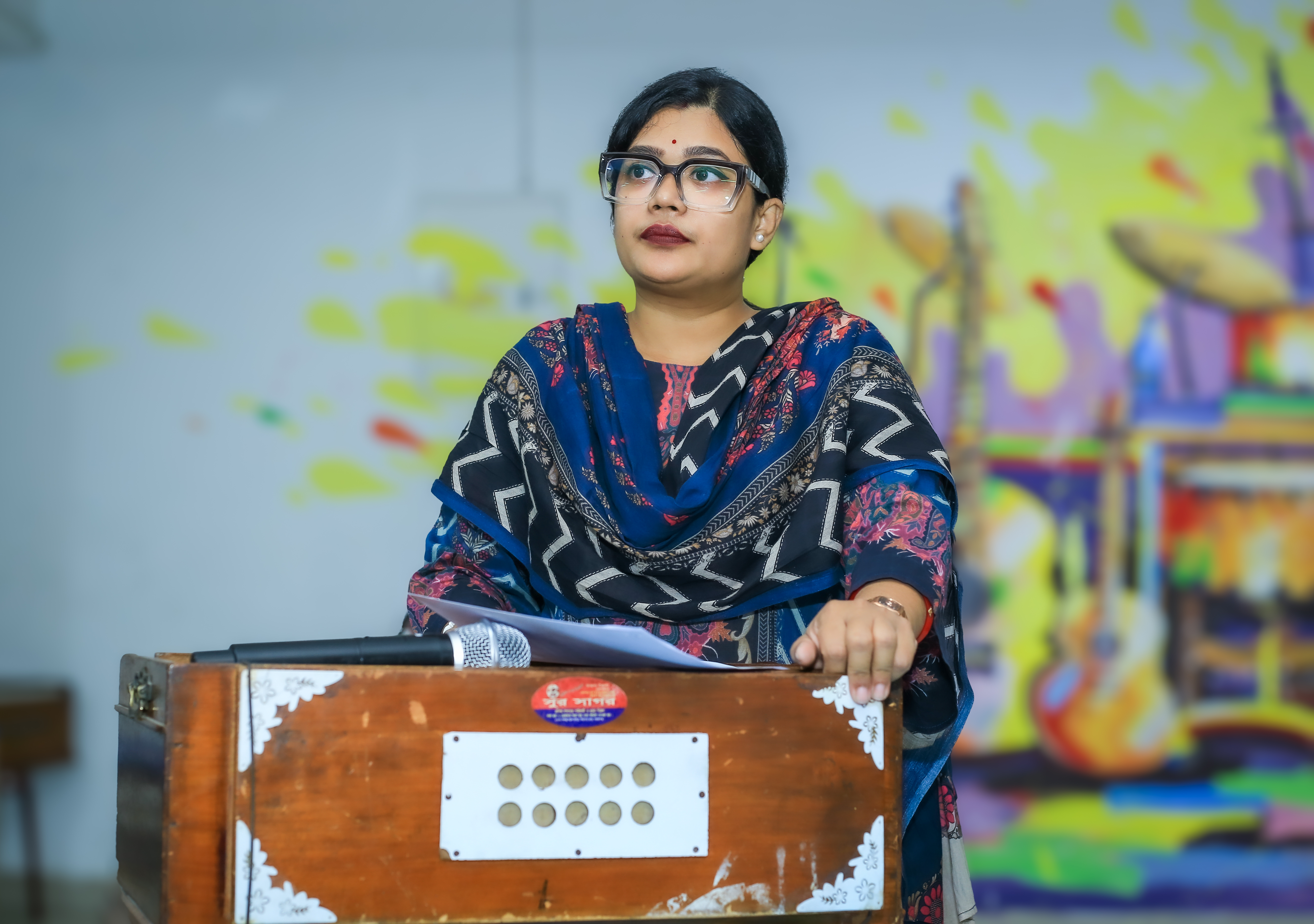 A student performing with a harmonium during the Day 02 ECA Festival